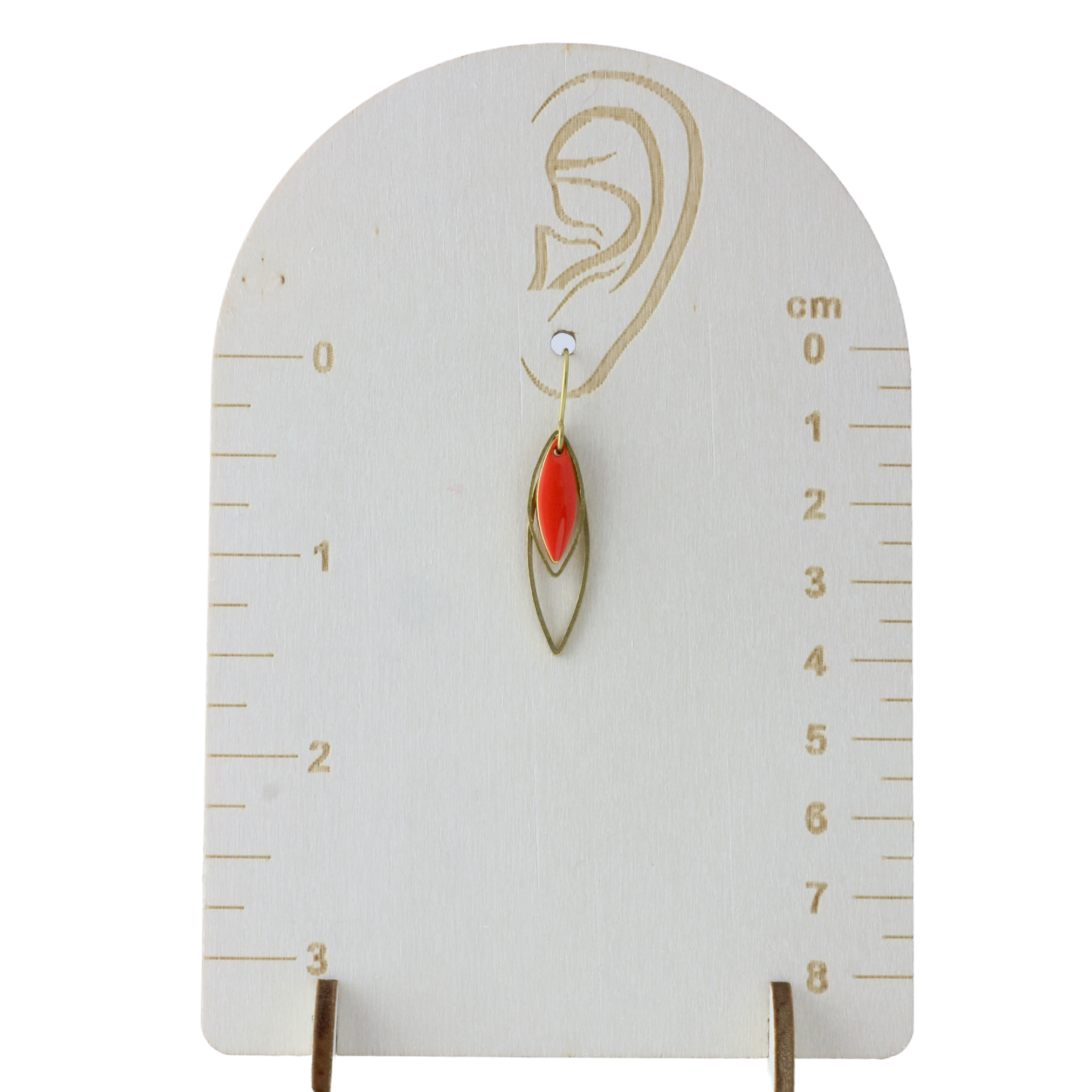 a pair of earrings with a red stone hanging from a hook