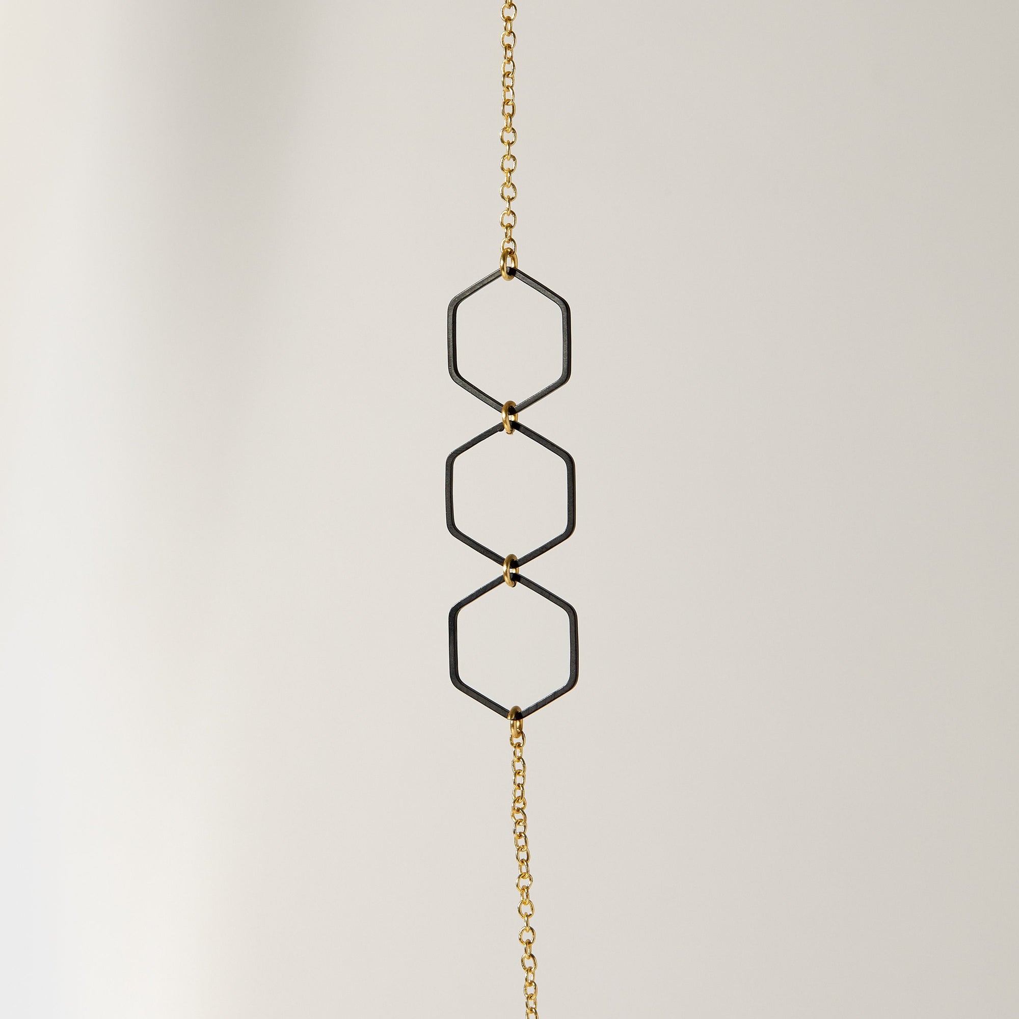 "Le Contour" Honeycomb Hexagon Black and Gold Long Necklace